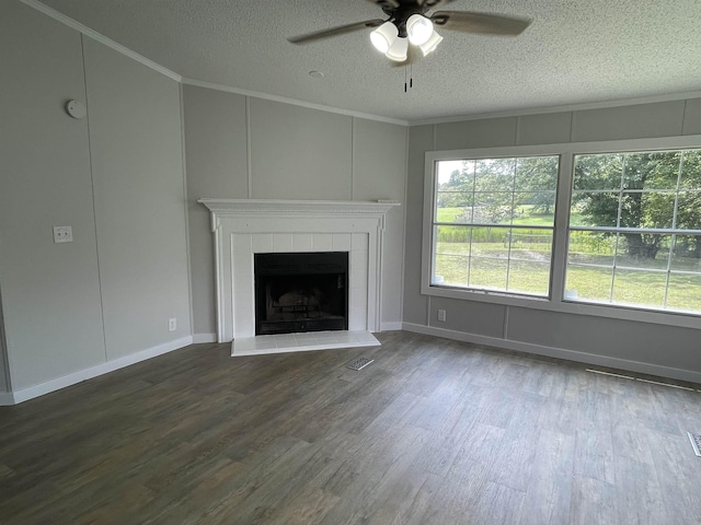 unfurnished living room featuring a tile fireplace, wood-type flooring, a textured ceiling, and ceiling fan