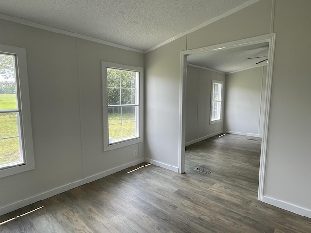 unfurnished room with lofted ceiling, crown molding, a textured ceiling, and hardwood / wood-style flooring