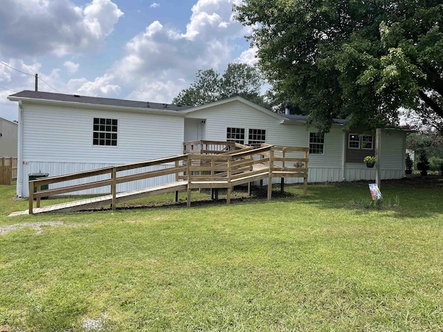 rear view of property featuring a yard and a deck