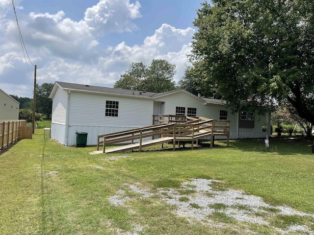 back of house featuring a yard and a deck