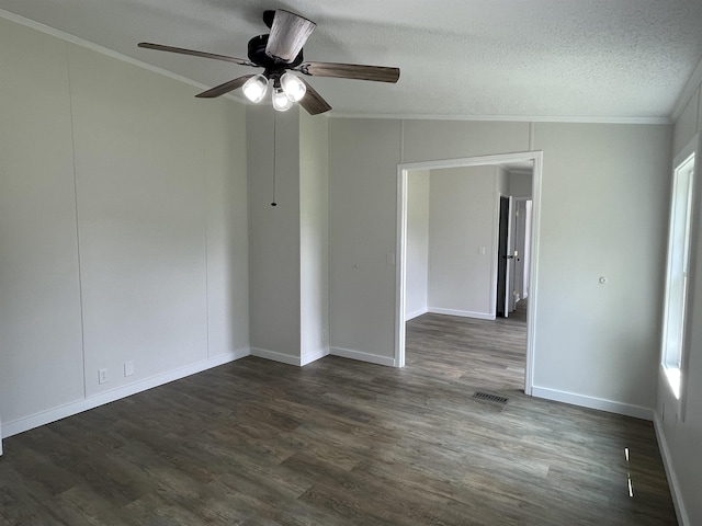 spare room featuring ceiling fan, dark hardwood / wood-style flooring, ornamental molding, and a textured ceiling