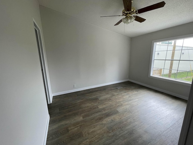 spare room with a textured ceiling, dark hardwood / wood-style floors, and ceiling fan