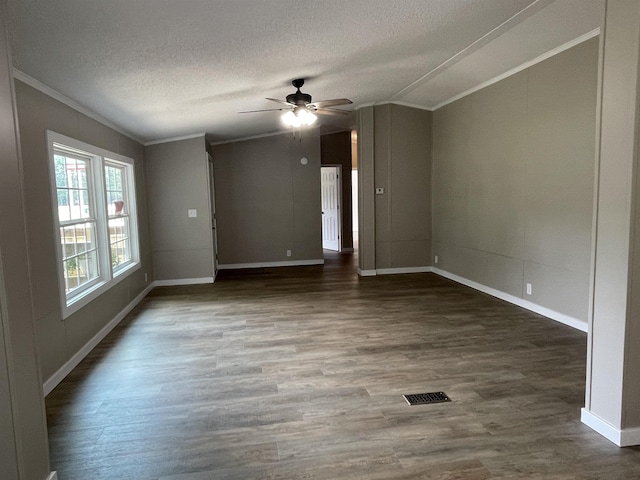 spare room with ceiling fan, dark hardwood / wood-style flooring, a textured ceiling, and ornamental molding