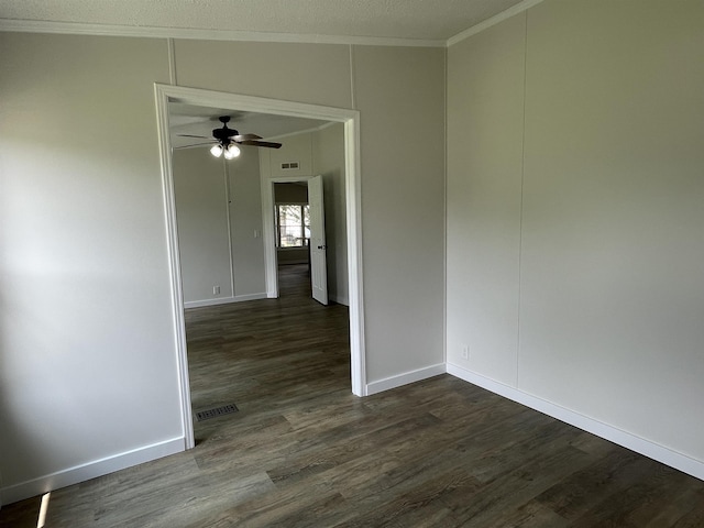 empty room with dark hardwood / wood-style floors, ceiling fan, and ornamental molding