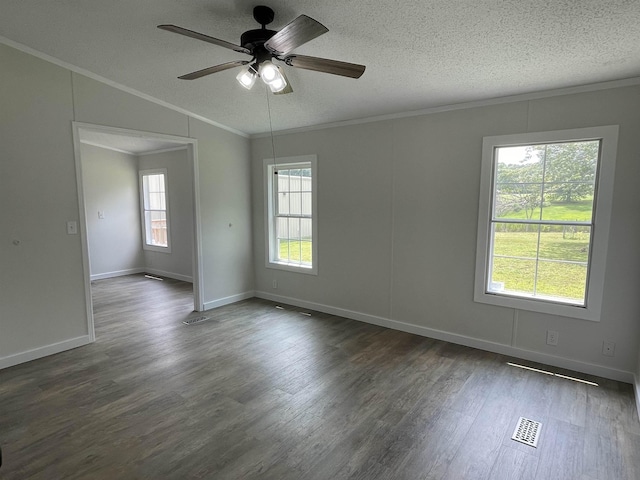 empty room featuring dark hardwood / wood-style flooring, ceiling fan, crown molding, and a healthy amount of sunlight