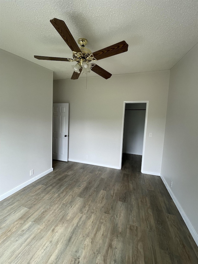 unfurnished room with dark hardwood / wood-style floors and a textured ceiling