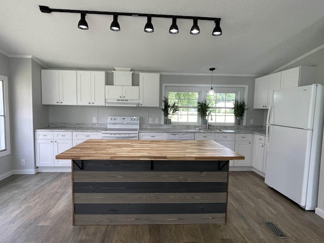 kitchen with white cabinets, butcher block countertops, white appliances, and a textured ceiling