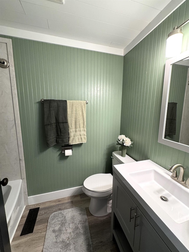 bathroom with vanity, toilet, and hardwood / wood-style floors