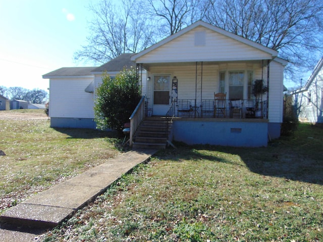 bungalow with a porch and a front lawn