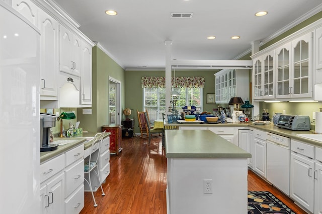  - kitchen with white dishwasher, crown molding, white cabinets, glass insert cabinets, and dark wood-style floors