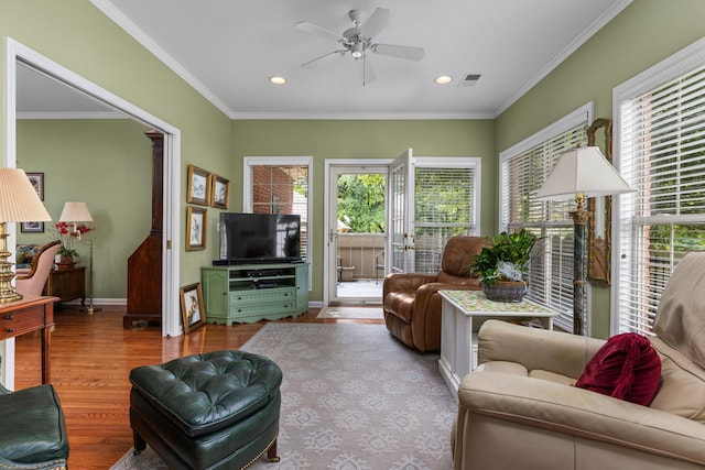  - living room featuring plenty of natural light, a ceiling fan, wood finished floors, baseboards, and ornamental molding