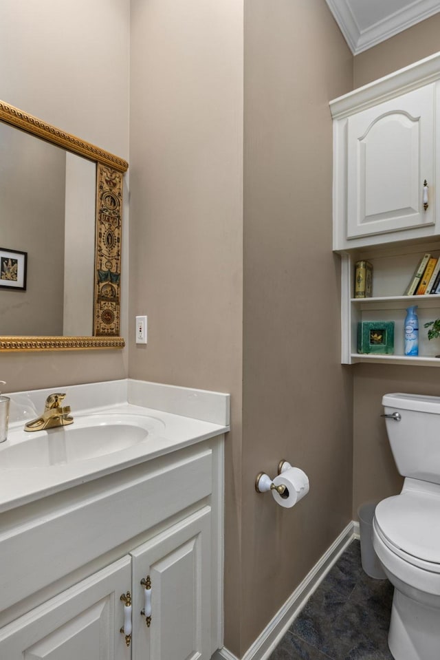  - bathroom featuring toilet, vanity, ornamental molding, and baseboards