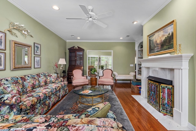  - living room featuring recessed lighting, wood finished floors, a ceiling fan, ornamental molding, and a high end fireplace