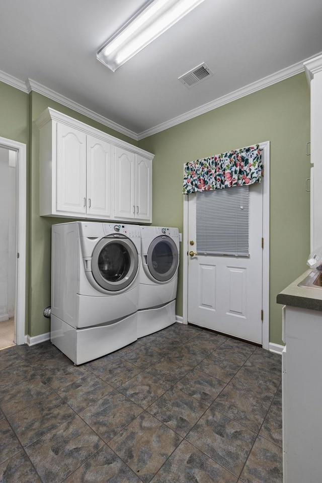  - laundry area with ornamental molding, separate washer and dryer, cabinet space, and baseboards