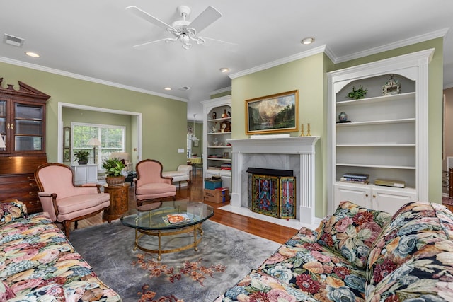  - living area featuring wood finished floors, ceiling fan, recessed lighting, a fireplace, and crown molding