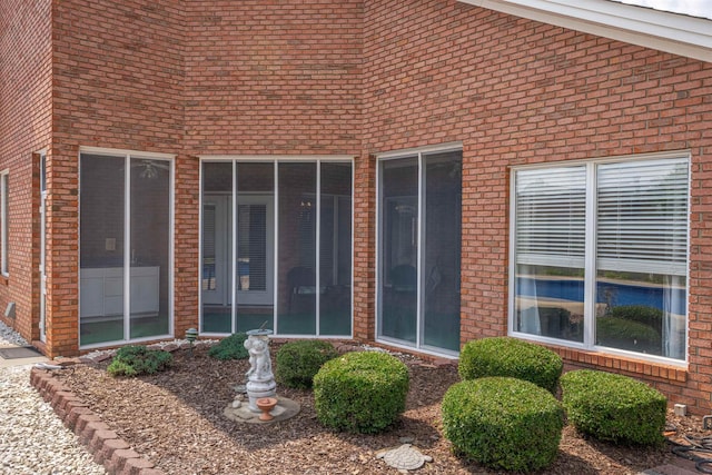  - view of exterior entry featuring brick siding