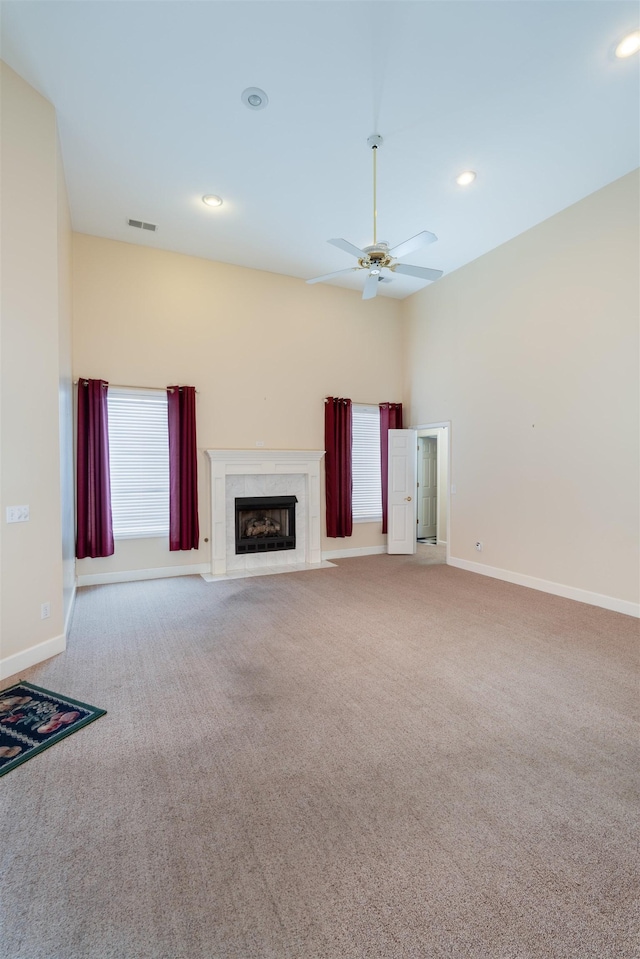  - unfurnished living room featuring carpet, a premium fireplace, a ceiling fan, and recessed lighting