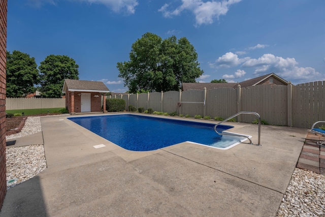  - view of swimming pool featuring a fenced backyard, a patio area, and an outdoor structure