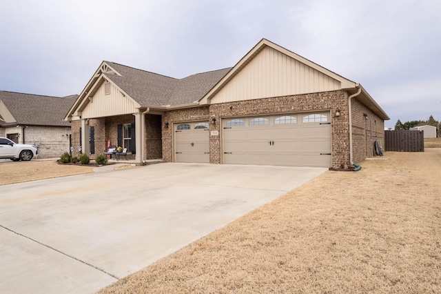 view of front facade with driveway, brick siding, an attached garage, and fence