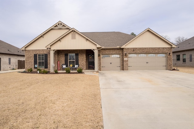 view of front of house featuring brick siding, a porch, concrete driveway, and a garage