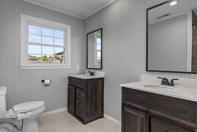 - bathroom featuring toilet, vanity, crown molding, tile patterned flooring, and baseboards