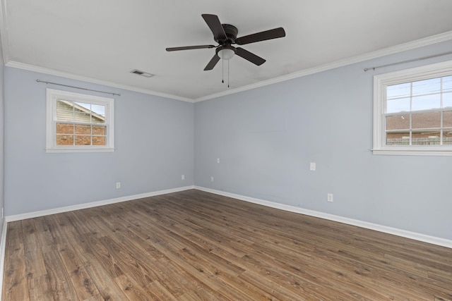  - spare room with plenty of natural light, baseboards, wood finished floors, ornamental molding, and a ceiling fan