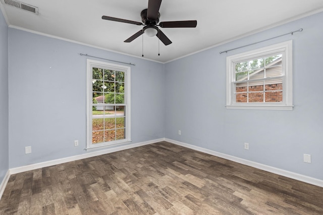  - spare room with wood finished floors, baseboards, plenty of natural light, and ornamental molding