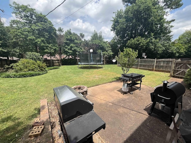  - view of patio with a trampoline and area for grilling