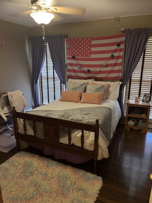  - bedroom featuring hardwood / wood-style flooring and ceiling fan