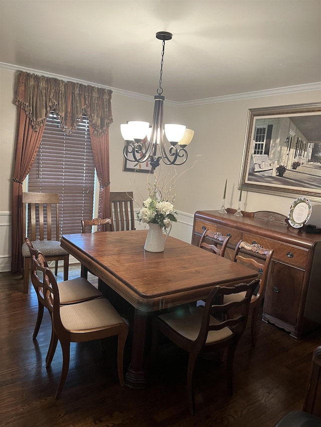  - dining space featuring a chandelier, ornamental molding, and dark wood-type flooring
