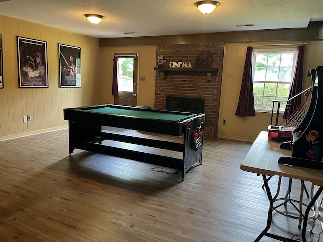  - rec room with light wood-style flooring, pool table, baseboards, healthy amount of natural light, and a textured ceiling