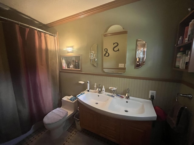 - full bathroom with ornamental molding, a wainscoted wall, toilet, a shower with shower curtain, and vanity