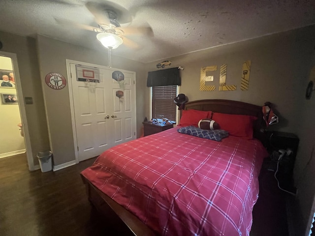  - bedroom with baseboards, a ceiling fan, wood finished floors, a closet, and a textured ceiling