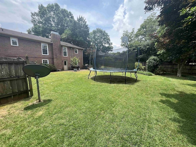  - view of yard with a trampoline