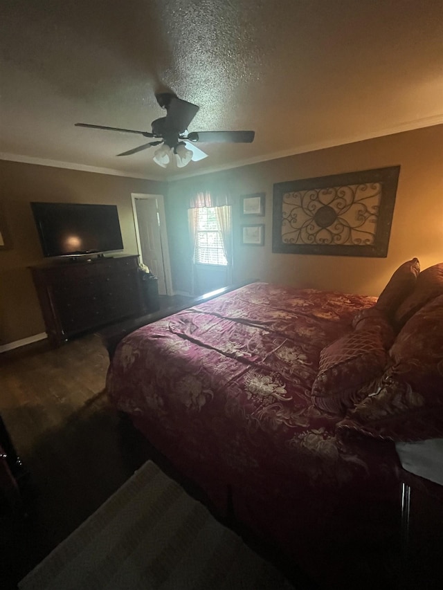  - bedroom featuring crown molding, wood finished floors, and ceiling fan