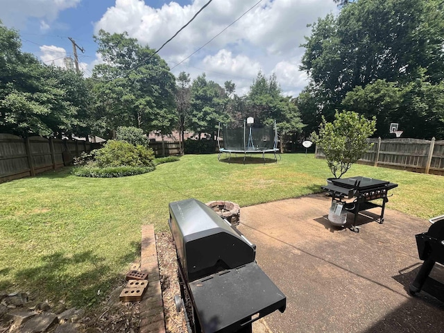  - view of yard featuring a trampoline and a patio area