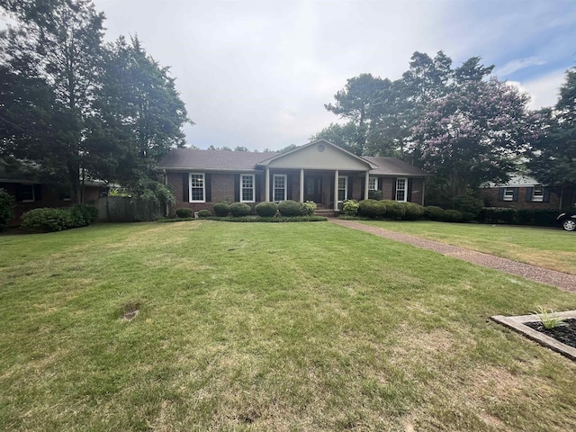  - ranch-style house featuring brick siding and covered porch
