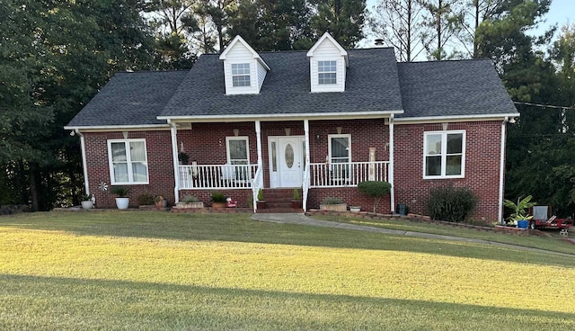 cape cod-style house featuring a porch and a front yard