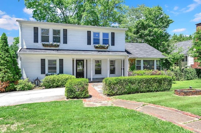  - traditional home featuring a porch and a front lawn