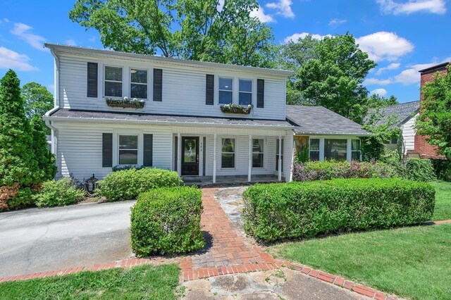  - traditional-style home featuring a porch