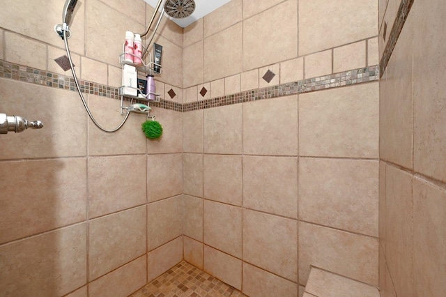  - bathroom featuring a tile shower