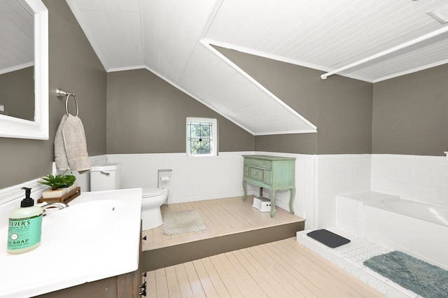  - bathroom featuring toilet, vaulted ceiling, wainscoting, and ornamental molding