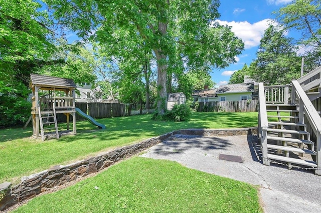  - view of yard featuring stairs, a patio, a fenced backyard, a playground, and an outdoor structure