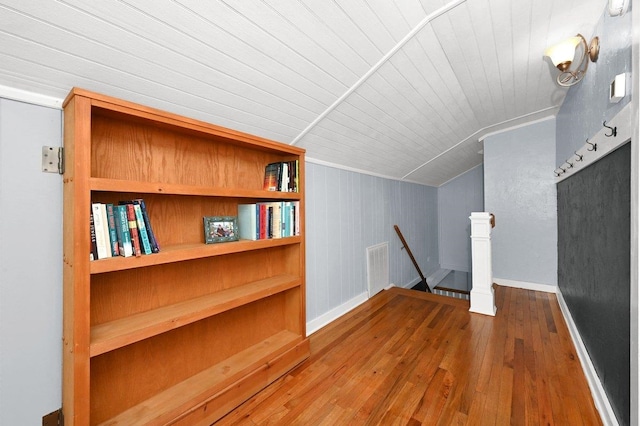  - additional living space featuring baseboards, lofted ceiling, wood ceiling, and hardwood / wood-style flooring