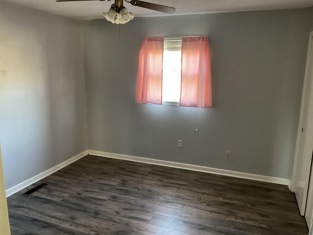 empty room featuring dark hardwood / wood-style floors and ceiling fan