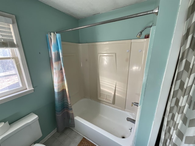 bathroom with toilet and shower / tub combo