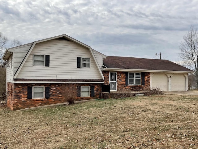 tri-level home featuring a garage and a front yard