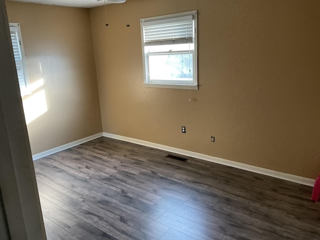 spare room with dark hardwood / wood-style flooring