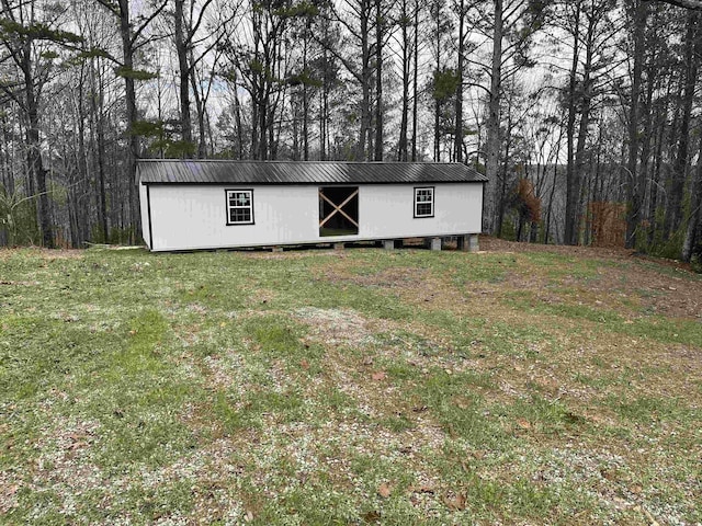 view of outdoor structure featuring a lawn