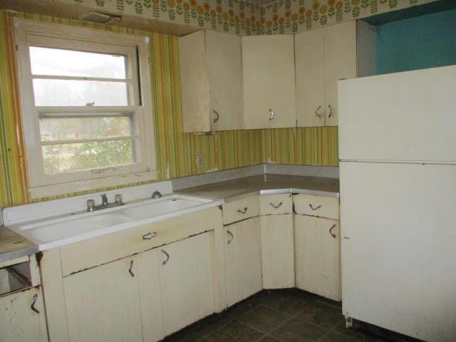 kitchen featuring sink and white fridge